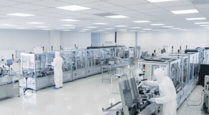 Sterile High Precision Manufacturing Laboratory where Scientists in Protective Coverall’s Turn on Machninery, Use Computers and Microscopes, doing Pharmaceutics, Biotechnology and Semiconductor Research.